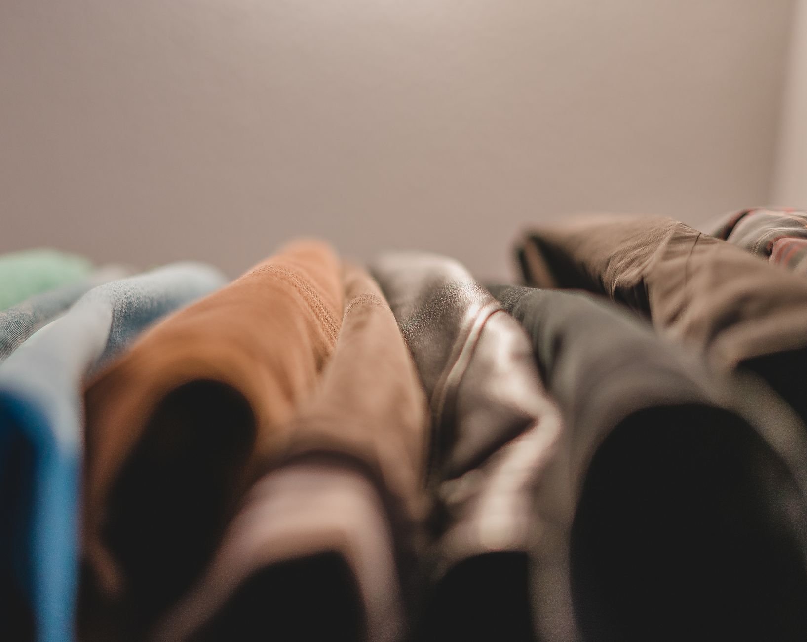 Textured close-up of folded fabric in warm lighting